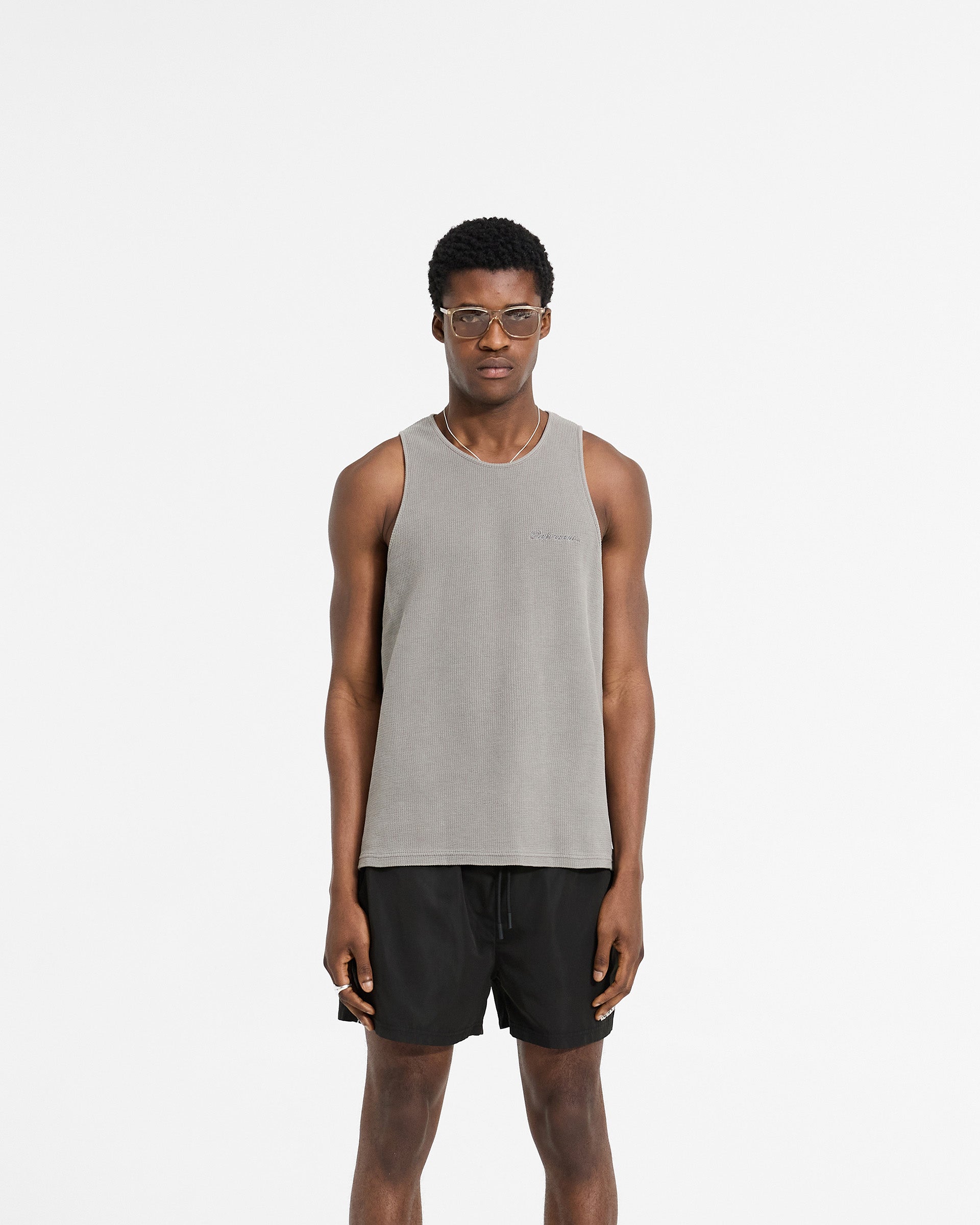Man wearing a grey vest on a plain white background | Waffle Vest in Ultimate Grey | Regular fit vest with mineral wash and embroidery | SC24 T-Shirts | Represent Clo