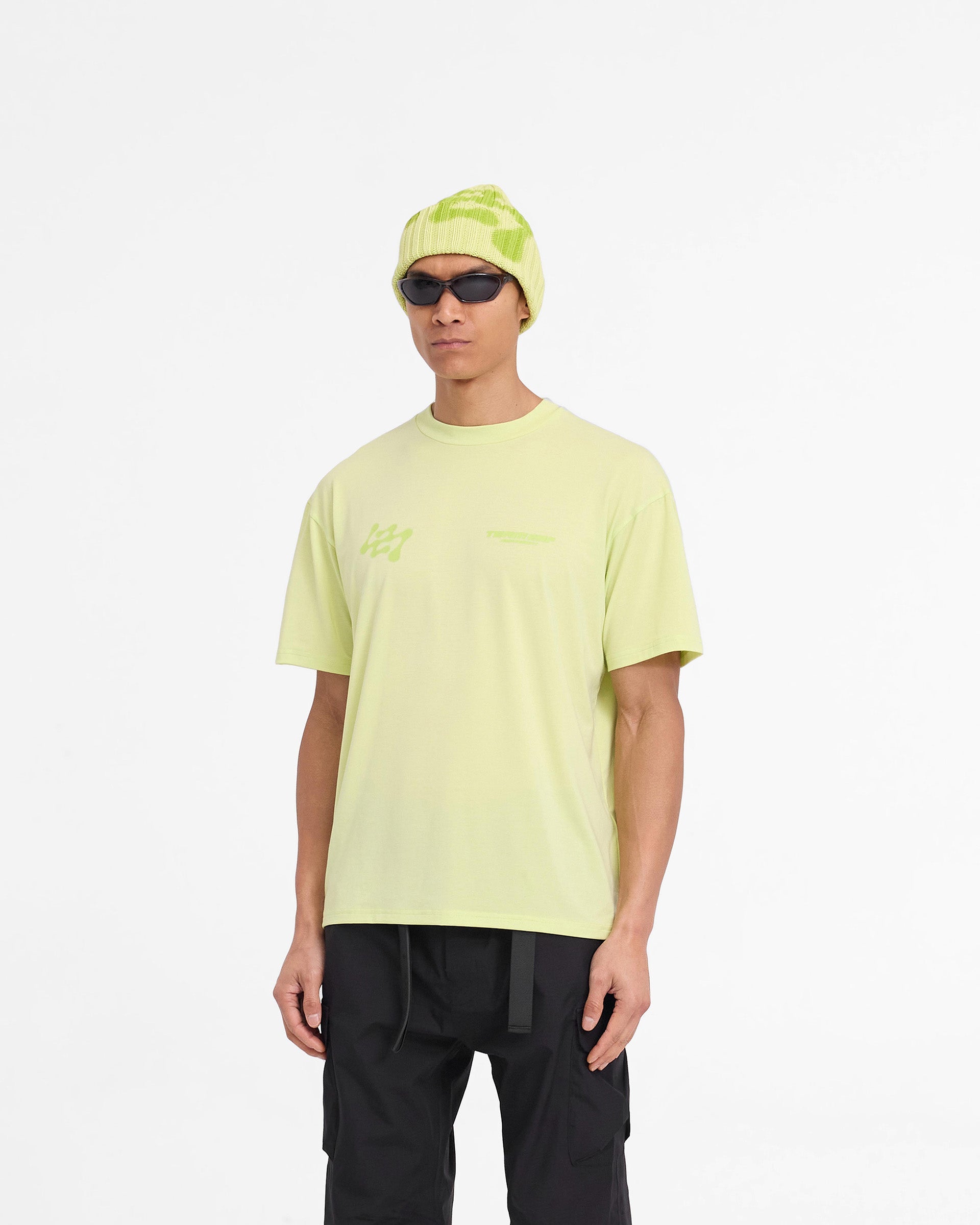Man wearing an oversized lime t-shirt on a plain white background | 247 Future Terrains Oversized T-Shirt in Shadow Lime | Lightweight training t-shirt with quick drying fabric | 247 T-Shirts | Represent Clo