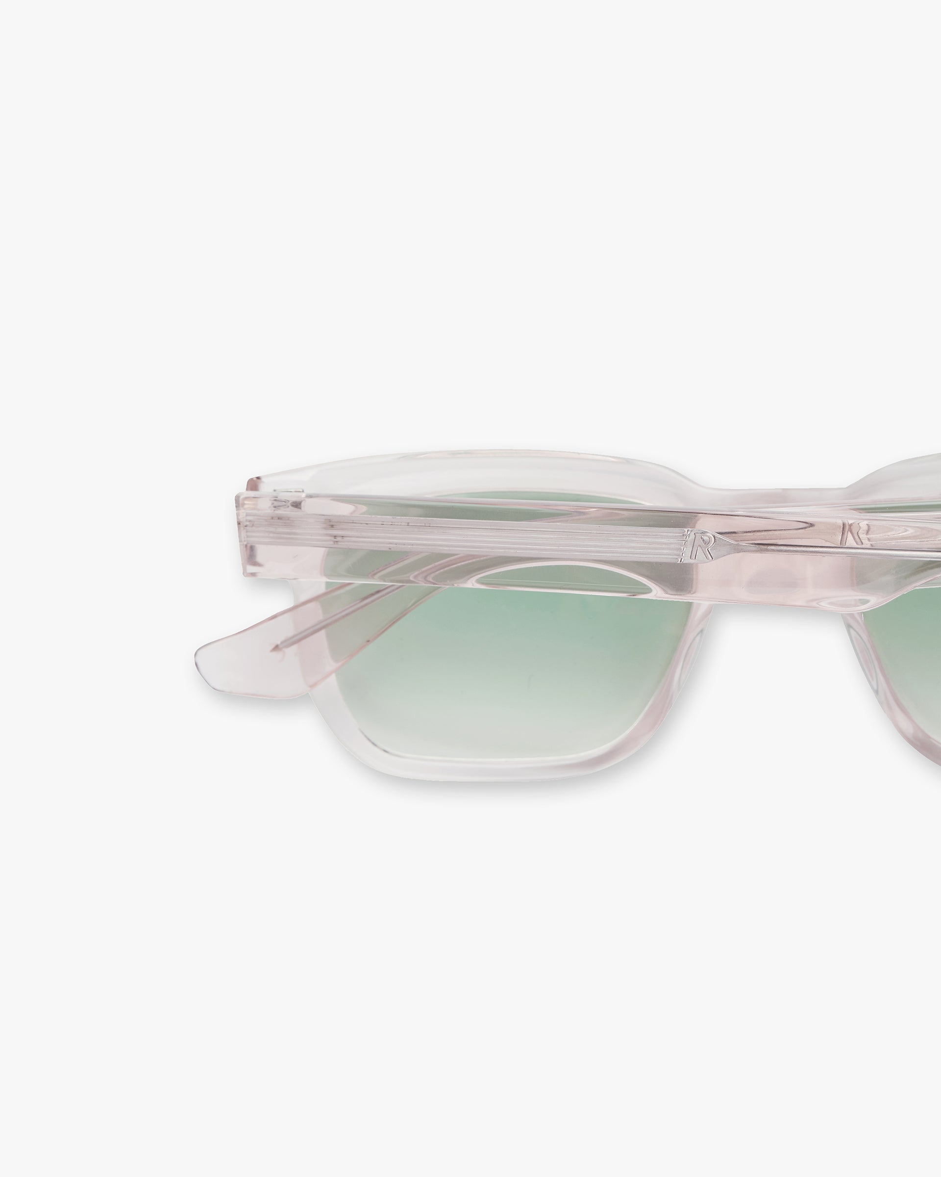 Close-up product image of pink sunglasses on a plain white background | Represent Hamptons Sunglasses in Pink Transparent | Acetate frames with visible brushed silver arm hinges | SS24 Accessories | Represent Clo