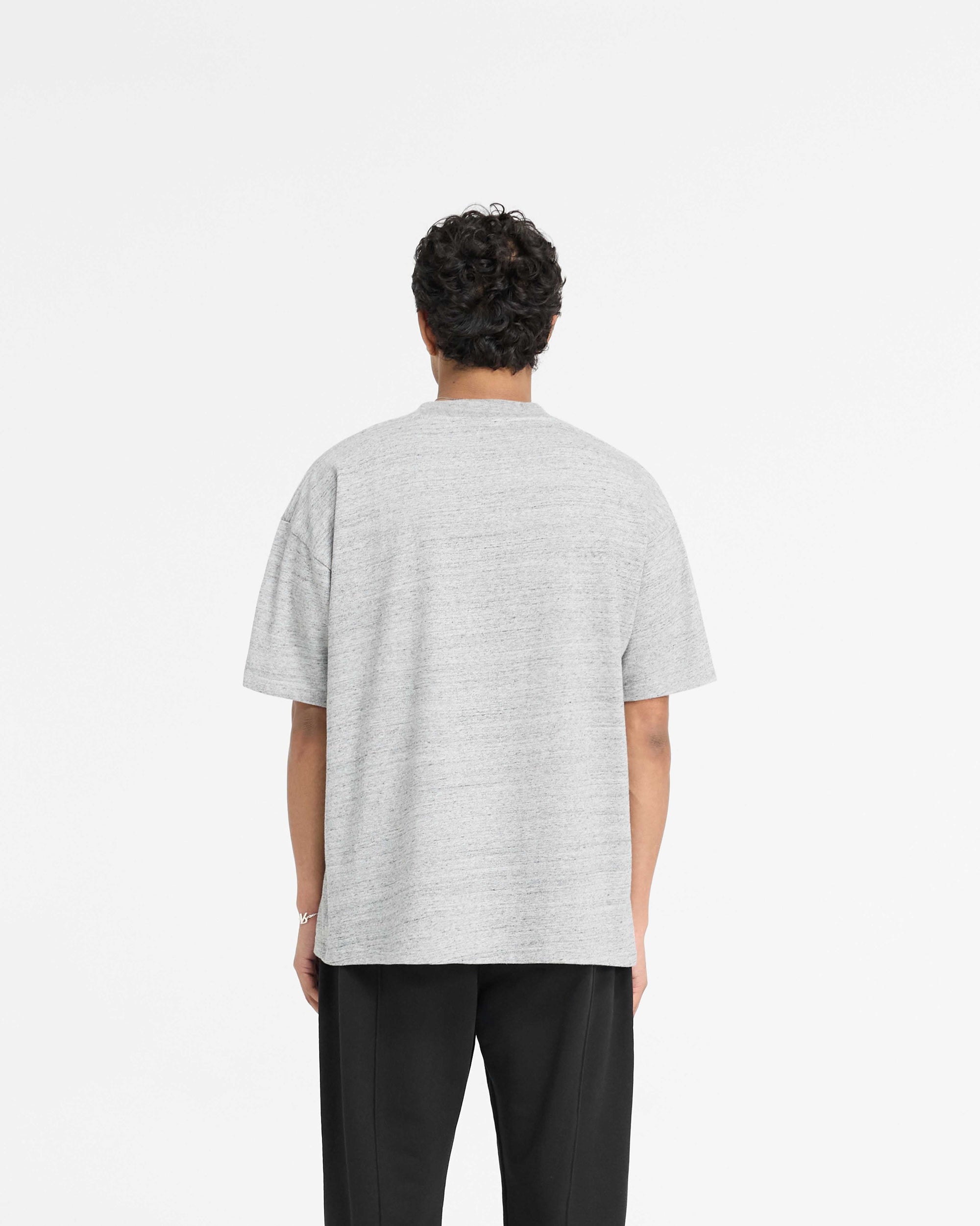 Man wearing a grey t-shirt on a plain white background | England Applique T-Shirt in Grey Marl | Slightly oversized t-shirt with embroidery | PRE SS25 T-Shirts | Represent Clo